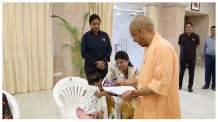 CM Gave Chocolate to the little Mayra CM Yogi During Janata Darshan